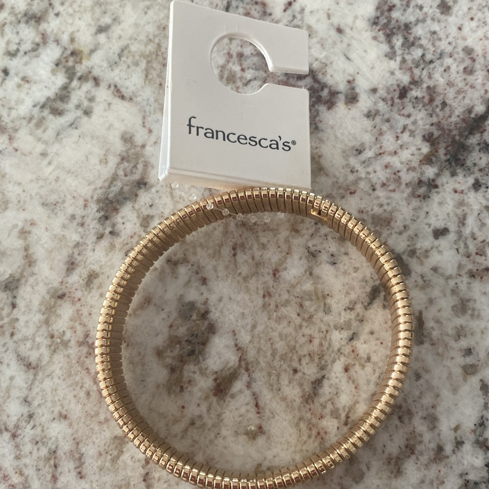 Francesca’s bangle bracelet gold tone about 2 1/2 inches across. NWT